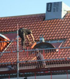 A man on a roof working on a roof